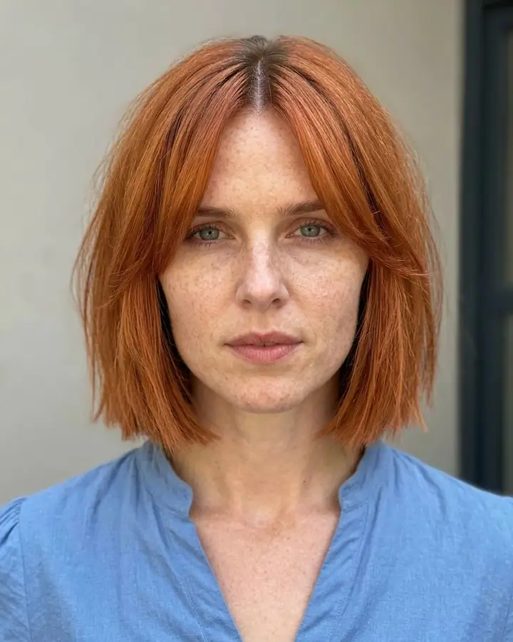 AI example of a woman's photo edited with a copper bob haircut