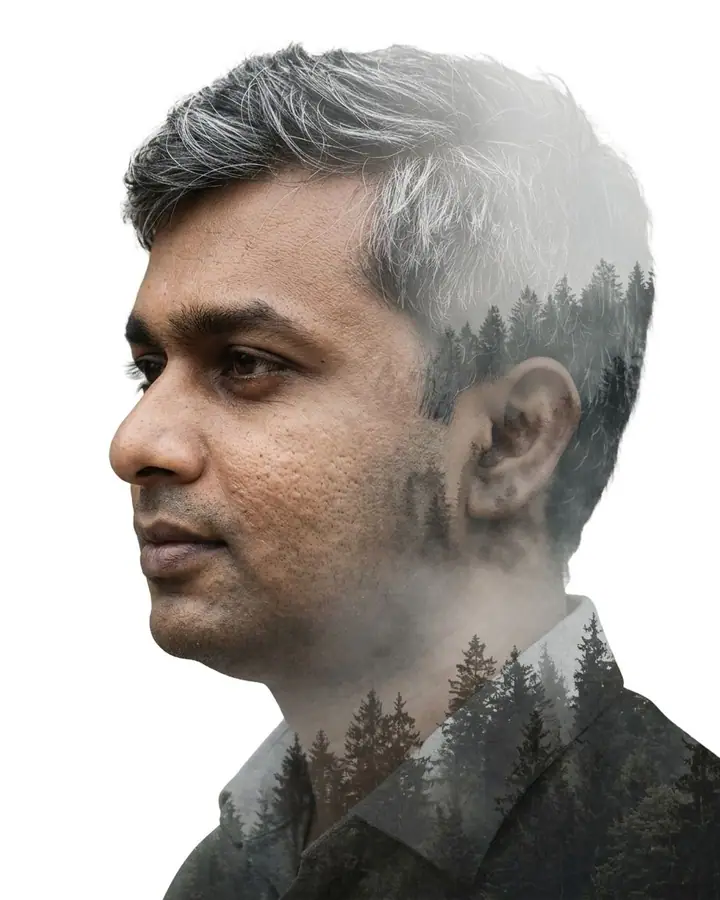 AI example of a double-exposure portrait merging a man's profile with a misty forest