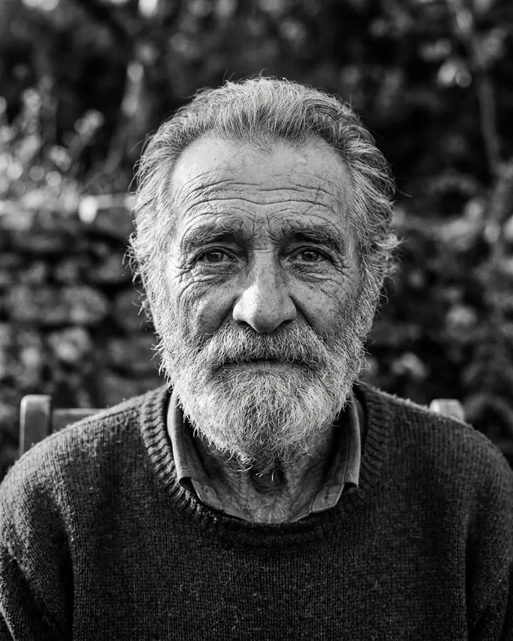 Black and white close-up portrait of an elderly bearded man