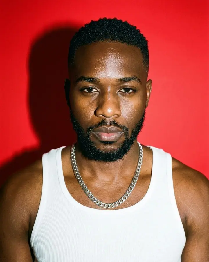 AI example of a hard-flash portrait of a man in front of a bold red backdrop