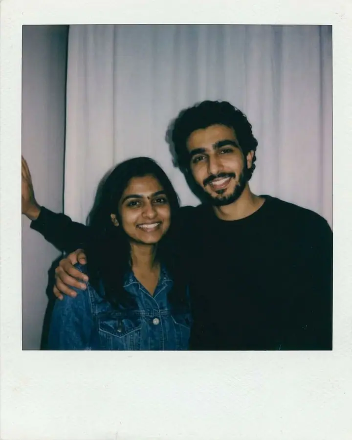 AI example of an instant-film photo of two friends posing together with a camera flash