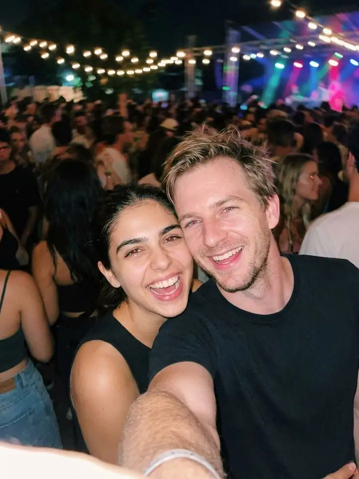 AI example of a blurry flash selfie of two friends laughing at a night event
