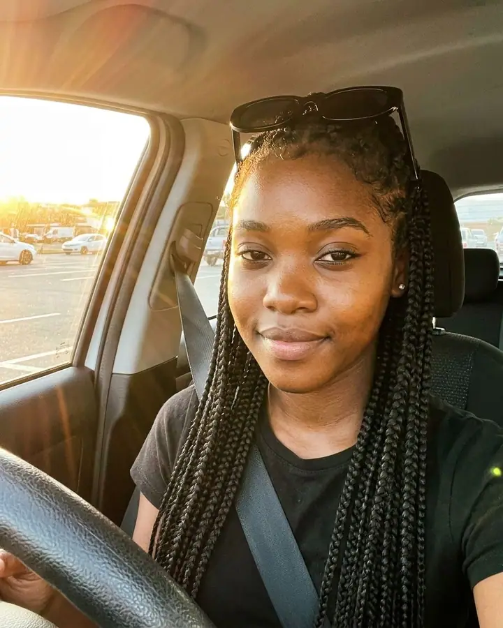 AI example of a warm golden-hour car selfie of a woman with sunglasses on her head